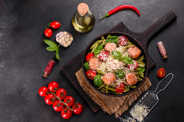 Delicious fresh pasta with meatballs, sauce, cherry tomatoes and basil