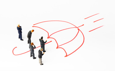 Miniature people on paper with painted umbrella. Business protection concept