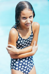 Little girl getting cold out of the pool water