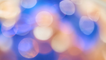Abstract blurred bokeh light. Purple yellow bokeh background. Defocused. Christmas lights background. Wallpaper. Copy space.