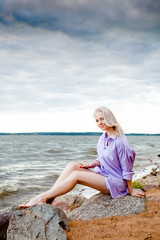 blonde girl by the sea / lake