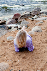 blonde girl by the sea / lake
