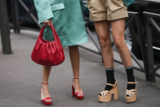 Paris, France – March 3, 2020: Red leather handbag and high heel sandals details - streetstylefw20