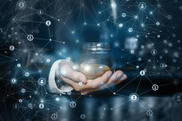 Businessman shows a jar of coins .