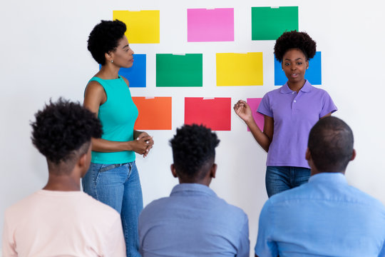 African American Female Students With Teacher And Audience