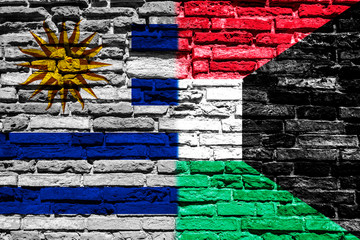 Flag of Uruguay and Kuwait on brick wall