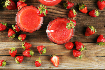 Glass of Sweet fresh strawberry juice and fresh strawberries on table. Healthy food and drink concept