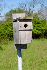 A close view of the box wooden birdhouse at the park.