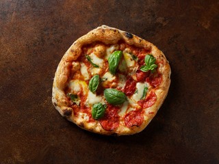 Italian pizza on a brown background