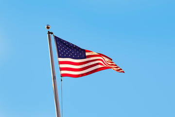 Stars and stripes under clear blue sky