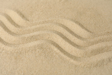 Fototapeta na wymiar Sand background with patterns, top view. Zen concept