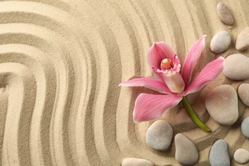 Fotobehang Zen Stenen Orchid and stones on sand background, top view. Zen concept  © Atlas