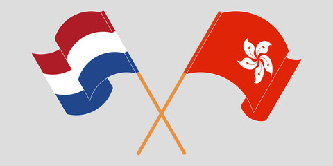 Crossed and waving flags of Hong Kong and the Netherlands