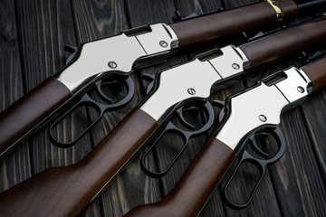 Cowboy rifles on a wooden back. Vintage rifles of the wild west. Weapons of cowboys, sheriffs and...