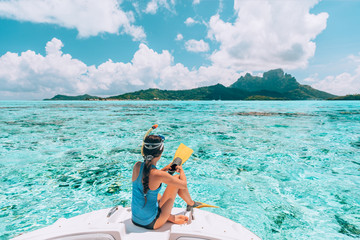 Snorkel diving excursion boat tour from yacht luxury travel influencer going swimming in coral reefs of Tahiti, French Polynesia Bora Bora island. - obrazy, fototapety, plakaty