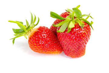 Red fresh strawberries on a white background. Green leaves of strawberries. Strawberry on a white background.