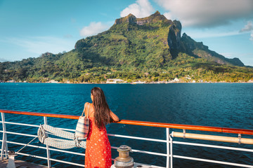 Cruise ship travel vacation luxury tourist woman looking at Bora Bora island view from deck of...