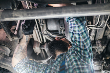 Professional car mechanic working in vehicle repair service.