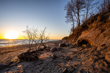 Beautiful romantic sunset at empty Karkle beach with many stones, Klaipeda/ Lithuania