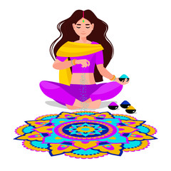 an Indian woman sits and makes rangoli from powders, chalk, marble dust, rice flour. The traditional picture of happiness on holiday Diwali