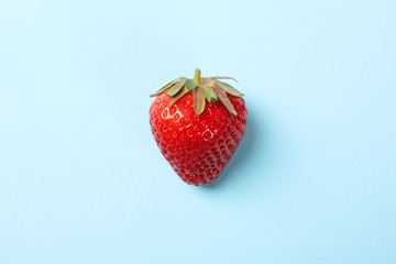 Tasty strawberry on blue background. Summer berry