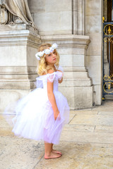 Girl ballerina Paris pose on old stone background. Old stone background. Beautiful model. Happy dancing people. Love fashion.