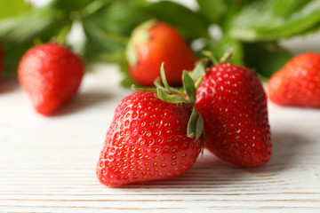 Tasty strawberry on white wooden background. Summer berry