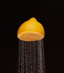 
juicy yellow lemon in the form of a shower