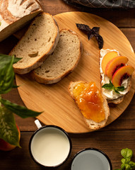 breakfast. buderbrodys with orange jam. and lying bread on the board