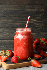 Composition with strawberry cocktail on gray table. Summer berry