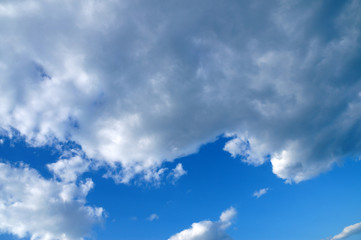 Naklejka na ściany i meble thick white clouds against blue sky before the rain