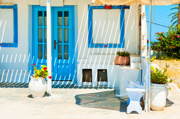 Traditional greek white architecture with blue doors and windows. Santorini island, Greece.