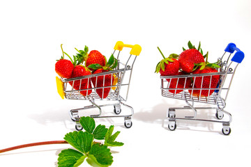 Red fresh strawberries in a little trolley from a super layout.