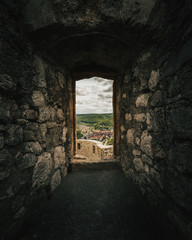 Dark stone window of the castle Hohenurach with view to the town Bad Urach