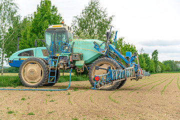 tractor adapted for spraying weeds and pests in field