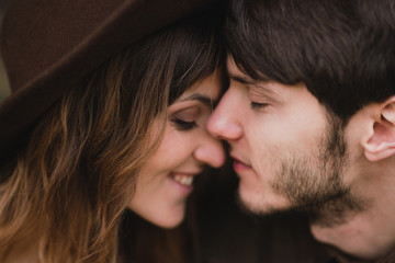 Obraz premium Romantic and happy caucasian couple in casual wedding clothes walking and hugging at the city streets. Love, relationships, romance, happiness, urban concept. Man and woman celebrate their marriage.