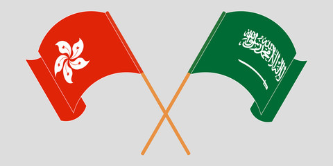 Crossed and waving flags of Hong Kong and the Kingdom of Saudi Arabia