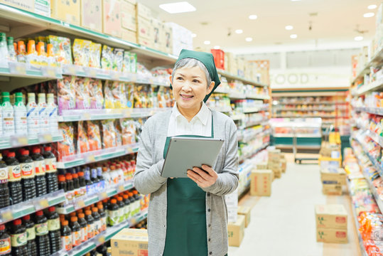 Senior woman checking restock in supermarket