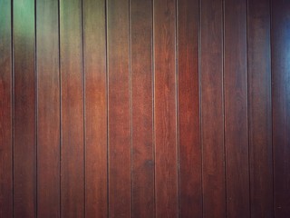 Brown vertical lacquered plank surface. Natural dark wood background for design.
