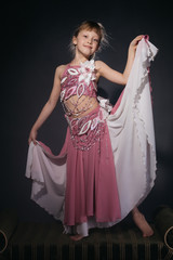 A little girl dressed as an belly dancer