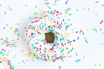 Donut decorated icing and sprinkles on white background 
