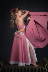 A little girl dressed as an belly dancer