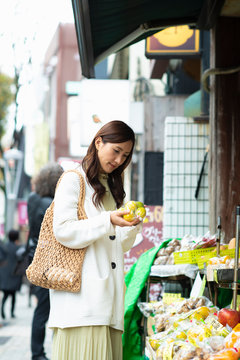 Woman shopping for fruit at store