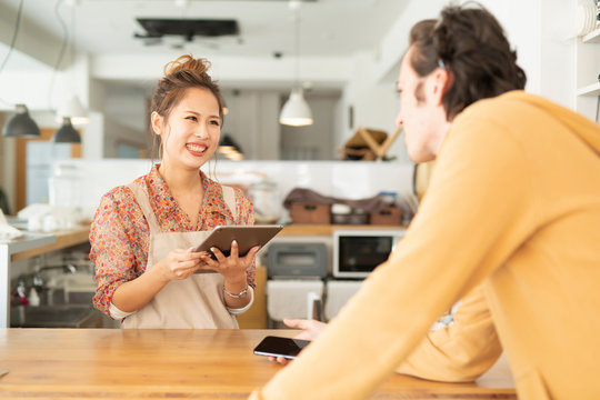 Young woman attending foreign tourist