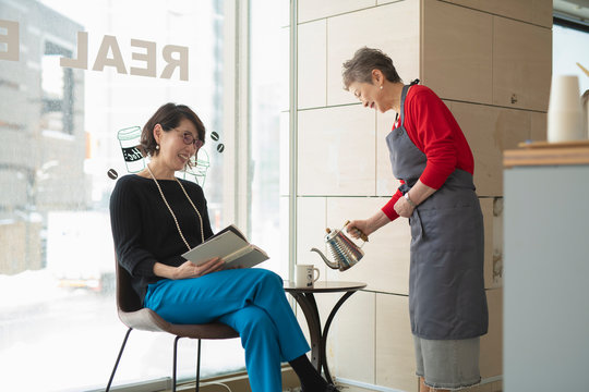 Shop clerk attending regular customer
