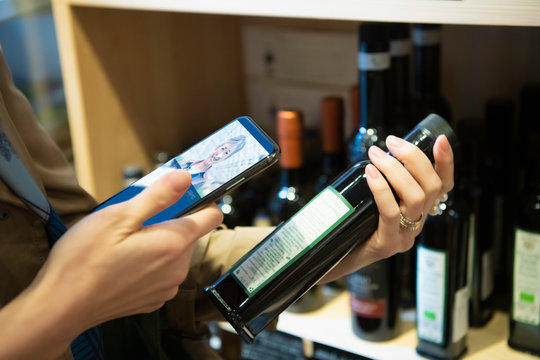 Woman checking product's information with AR application of smartphone