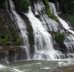 Large waterfalls flowing over rock ledges.