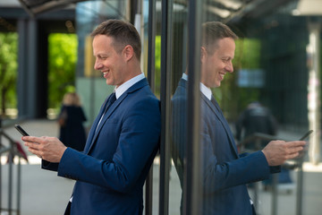 Handsome businessmen using phone outdoor