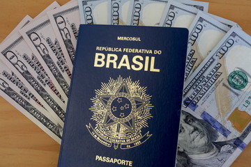 US dollar bills are seen under the Brazilian passport.