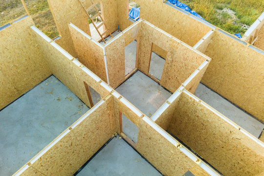 Construction of new and modern modular house. Walls made from composite wooden sip panels with styrofoam insulation inside. Building new frame of energy efficient home concept.